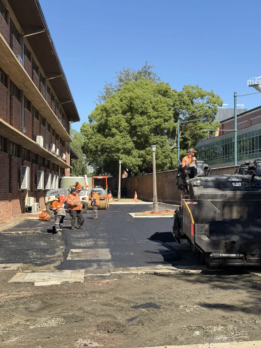 Baywa crew laying asphalt on a campus road